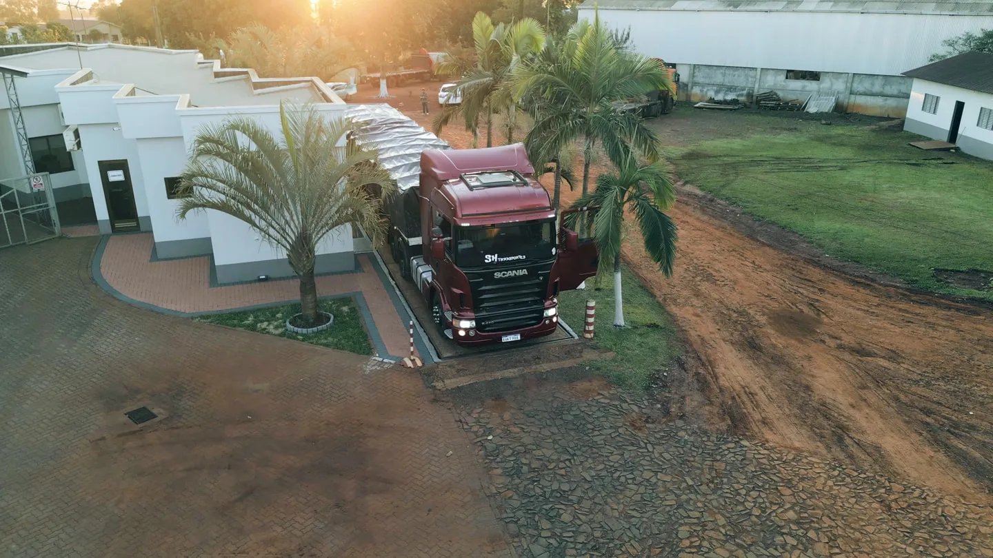 A truck at the entrance of a chia cleaning facility surrounded by farmland
